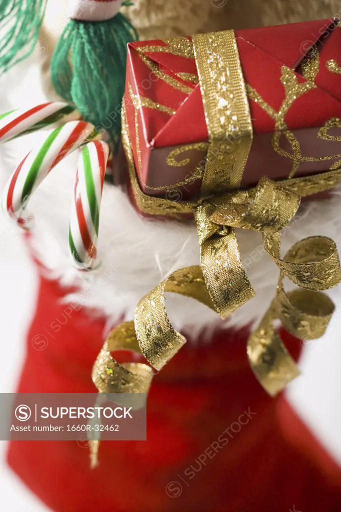 Closeup of Christmas stocking with candy canes and ribbon
