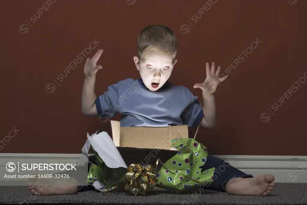 Young boy opening present