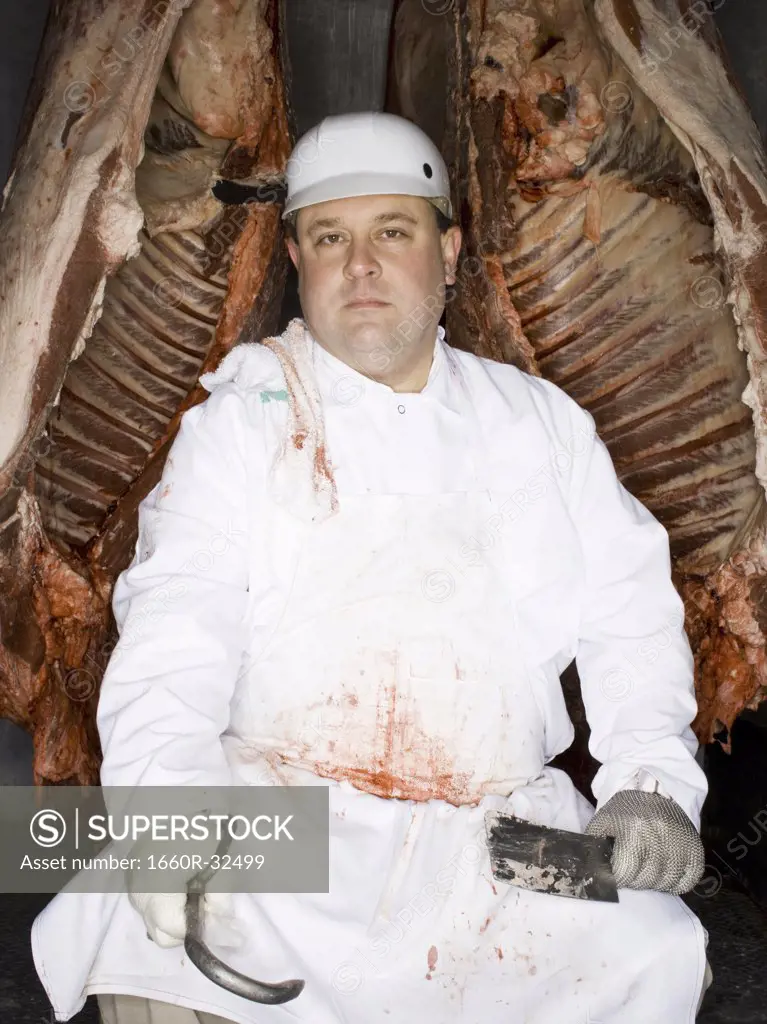 Butcher sitting with carcass and meat hook