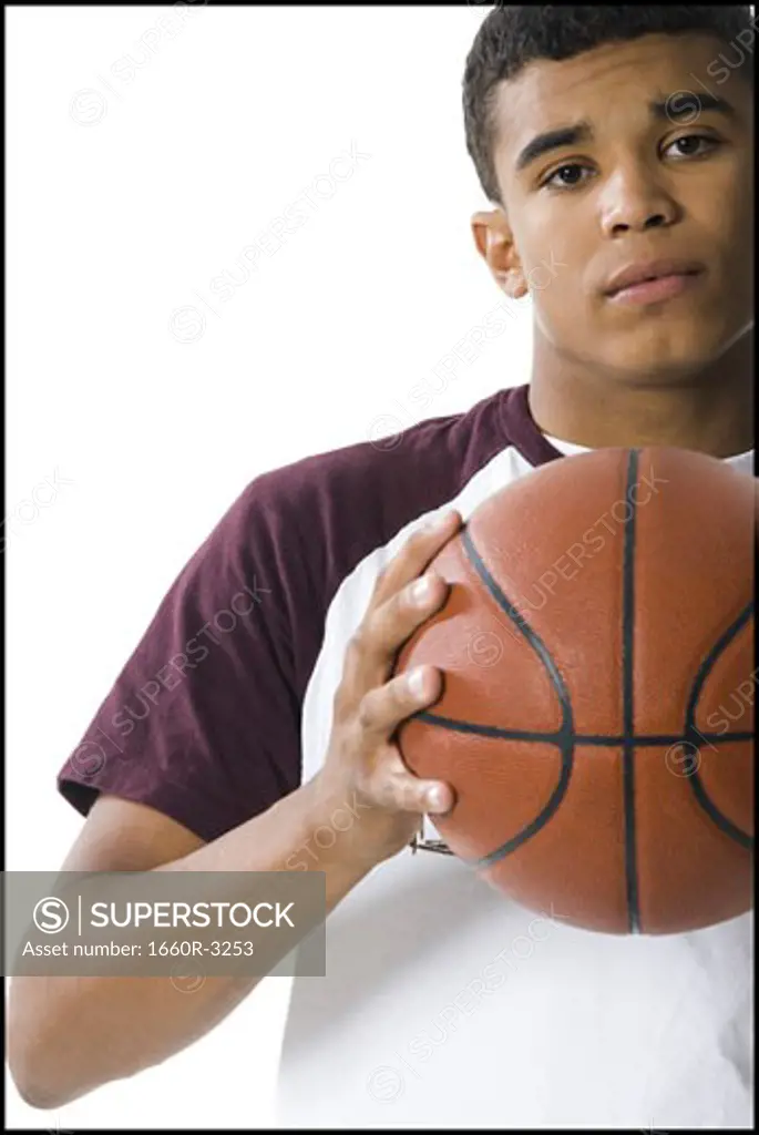 Portrait of a young man holding a ball