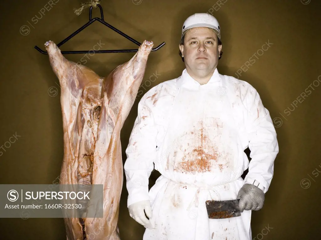 Butcher with hanging carcass and knife