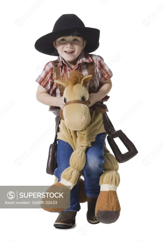 Boy with toy rifle and horse with cowboy hat