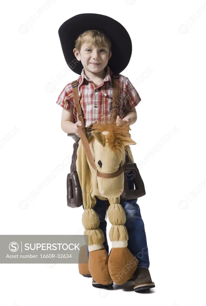 Boy with toy rifle and horse with cowboy hat