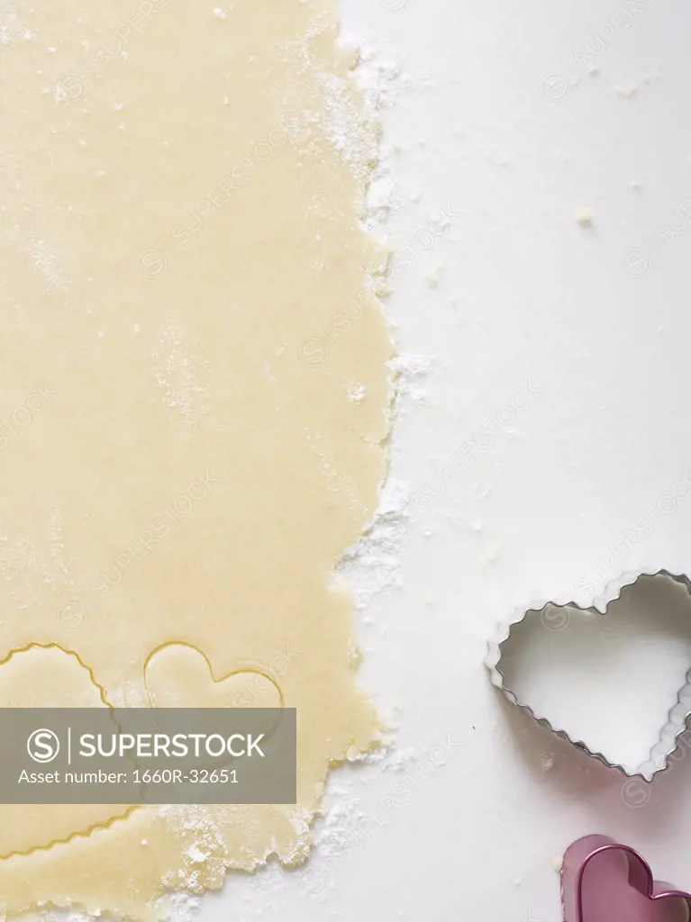 Detailed view of dough with heart cookie cutter