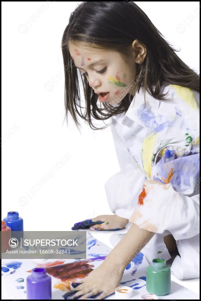 Young girl finger painting