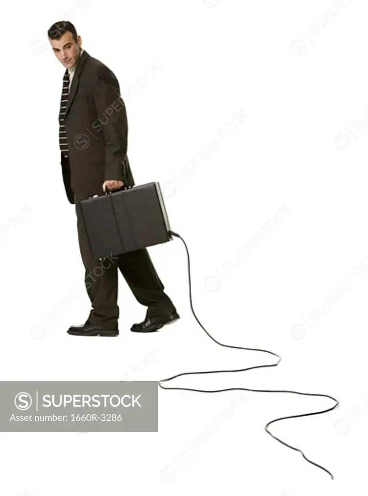 Portrait of a businessman holding a briefcase with an electrical cord