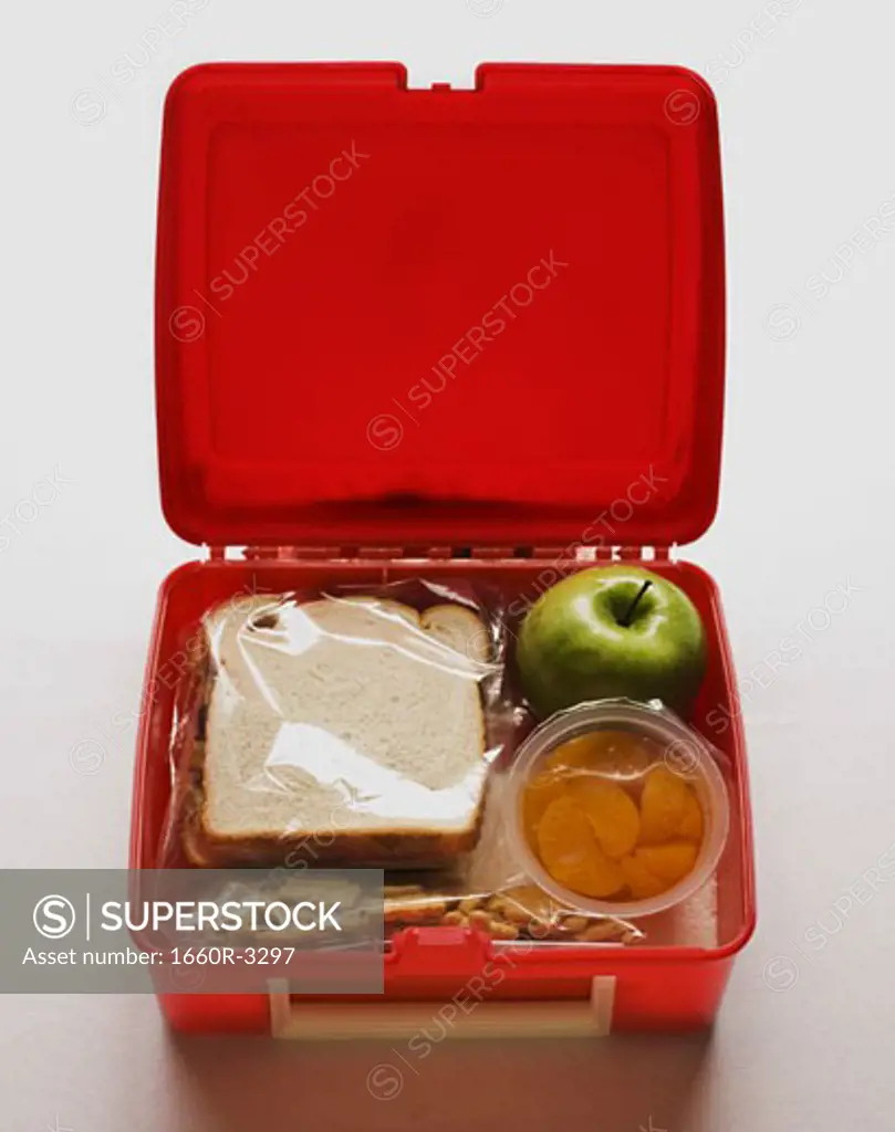 A lunch box with a sandwich and snacks