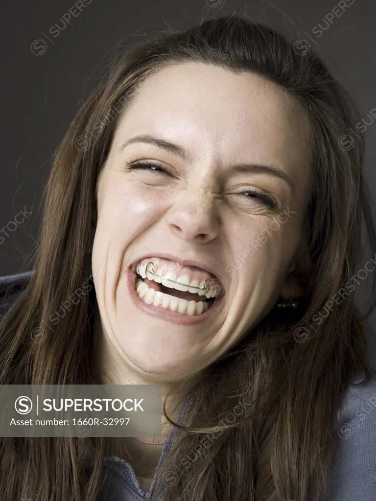 Woman smiling with dental retainer