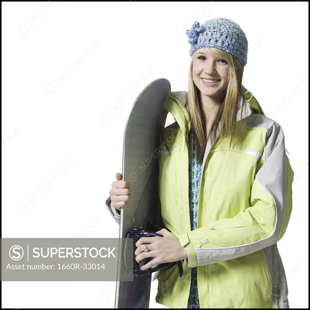 Girl with winter hat and skis smiling