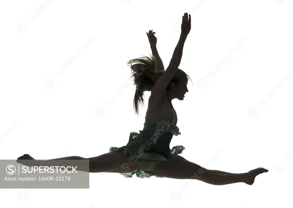 Side profile silhouette of ballerina leaping