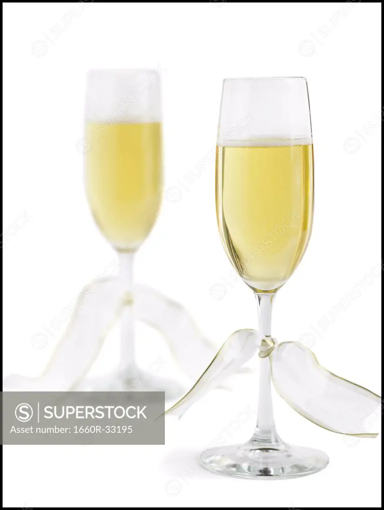 Two champagne flutes with champagne