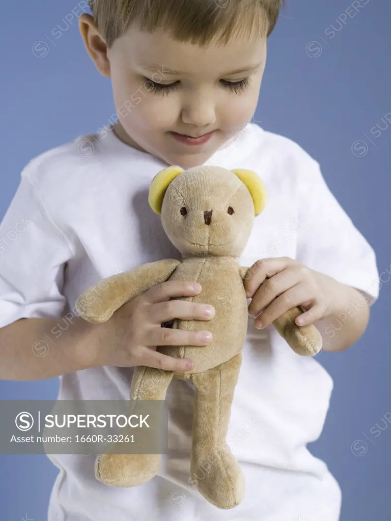 Closeup of boy holding teddy bear