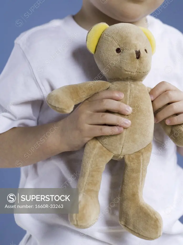 Closeup of boy holding teddy bear
