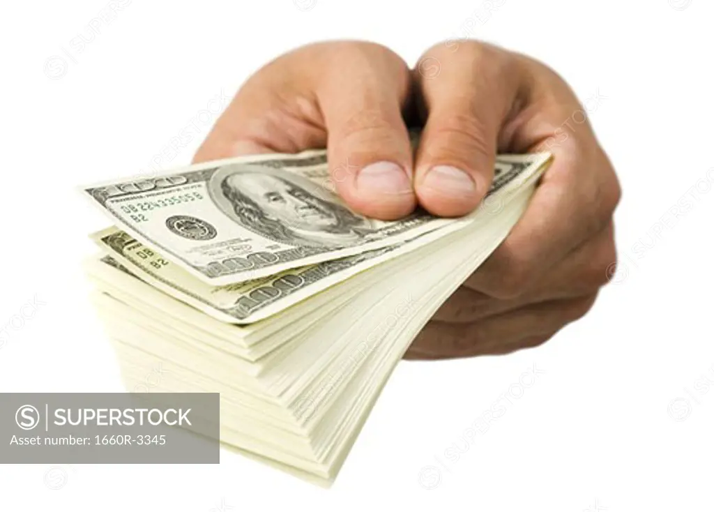 Close-up of hands holding paper currency