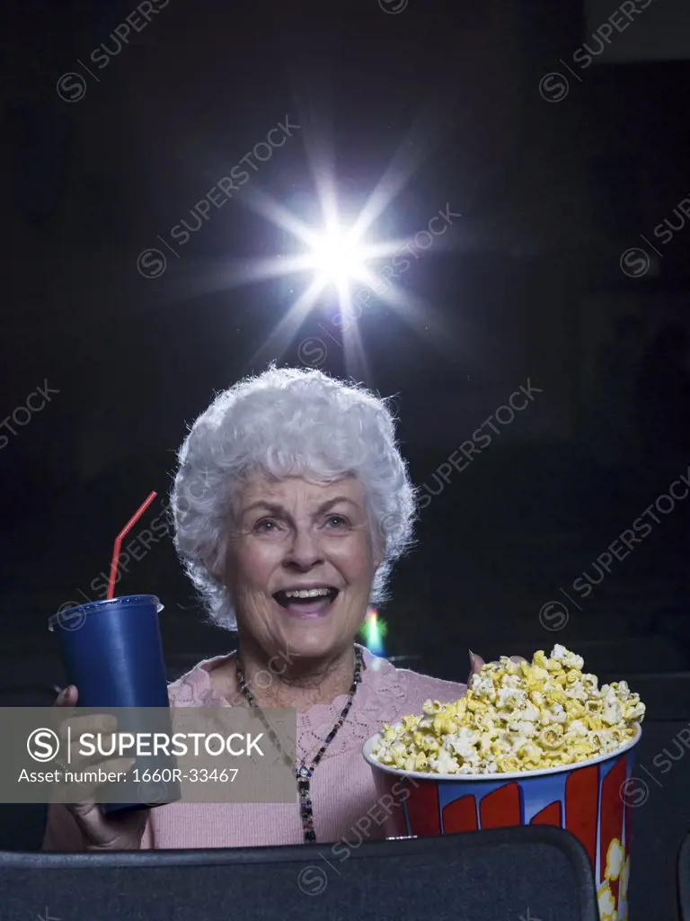 Woman watching film at movie theatre frightened