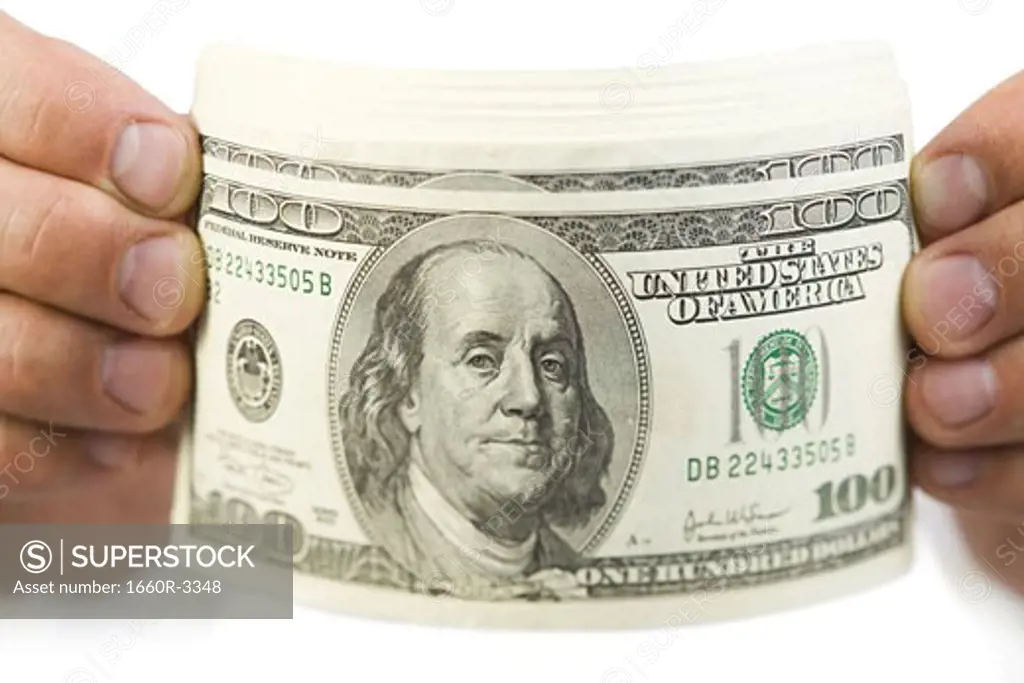 Close-up of a hands holding one hundred dollar bills