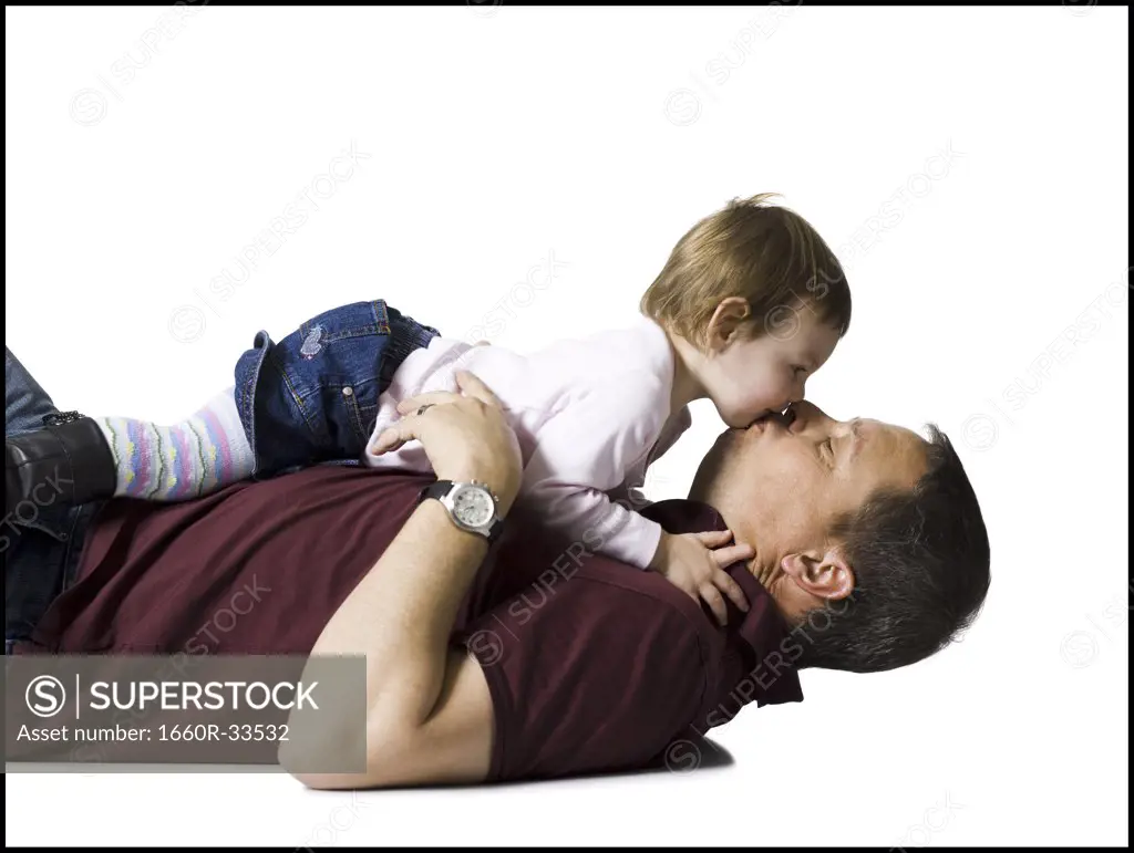 Side profile of man with baby girl snuggling