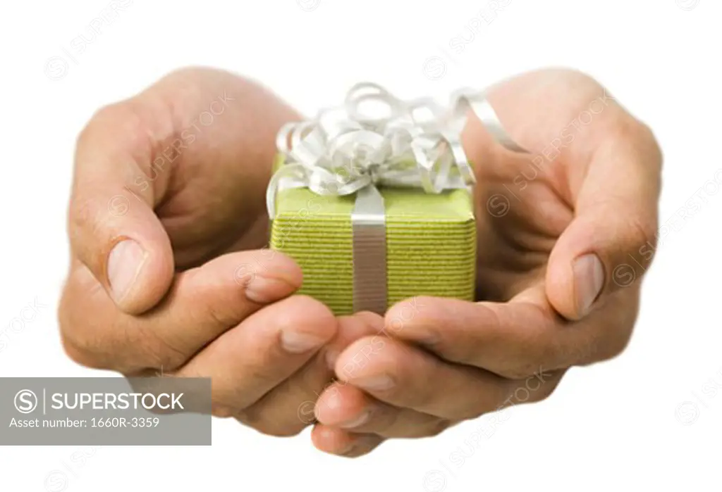 Close-up of hands holding a small gift