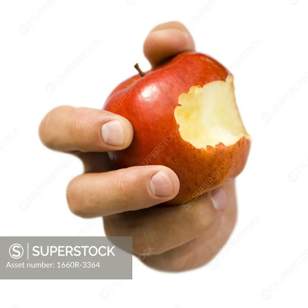 Close-up of a hand holding a bitten apple