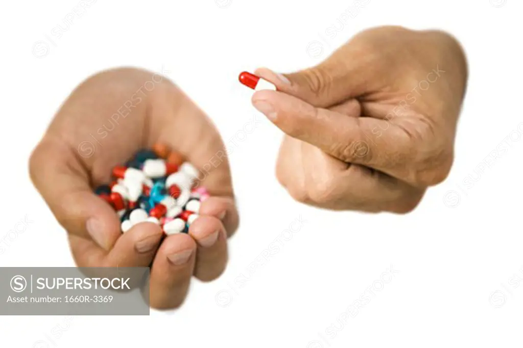 Close-up of hands holding pills