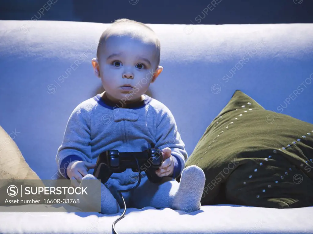Baby on sofa with video game controller