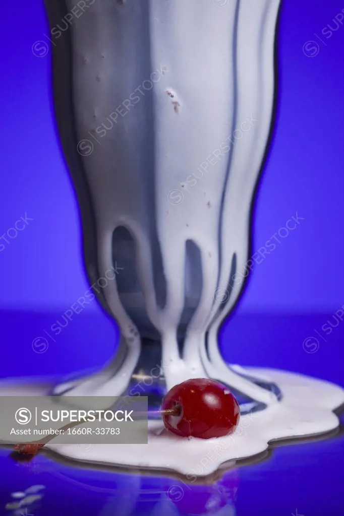Milkshake with two straws and maraschino cherry