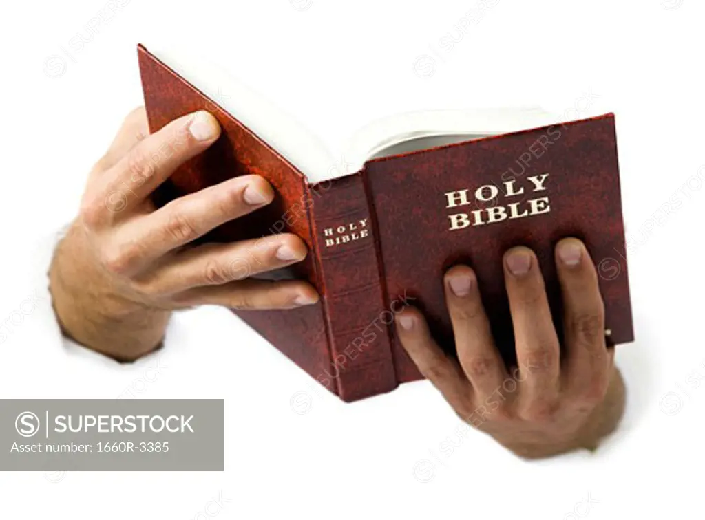 Close-up of hands holding the Bible
