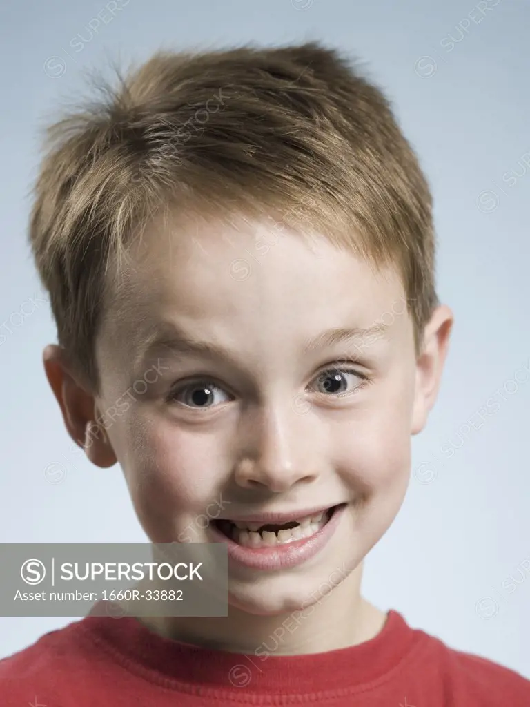 Close-up of boy smiling with missing front teeth
