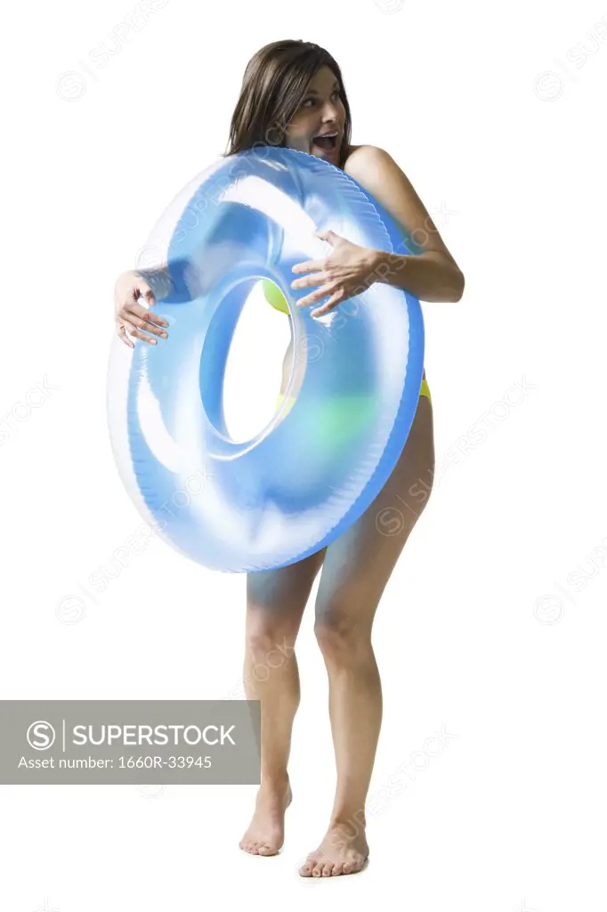 Woman in bikini hugging swimming ring
