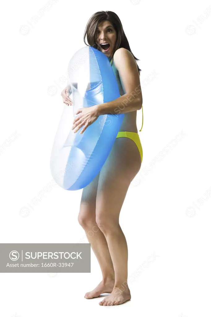 Woman in bikini hugging swimming ring