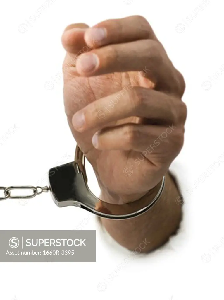 Close-up of hand in handcuffs
