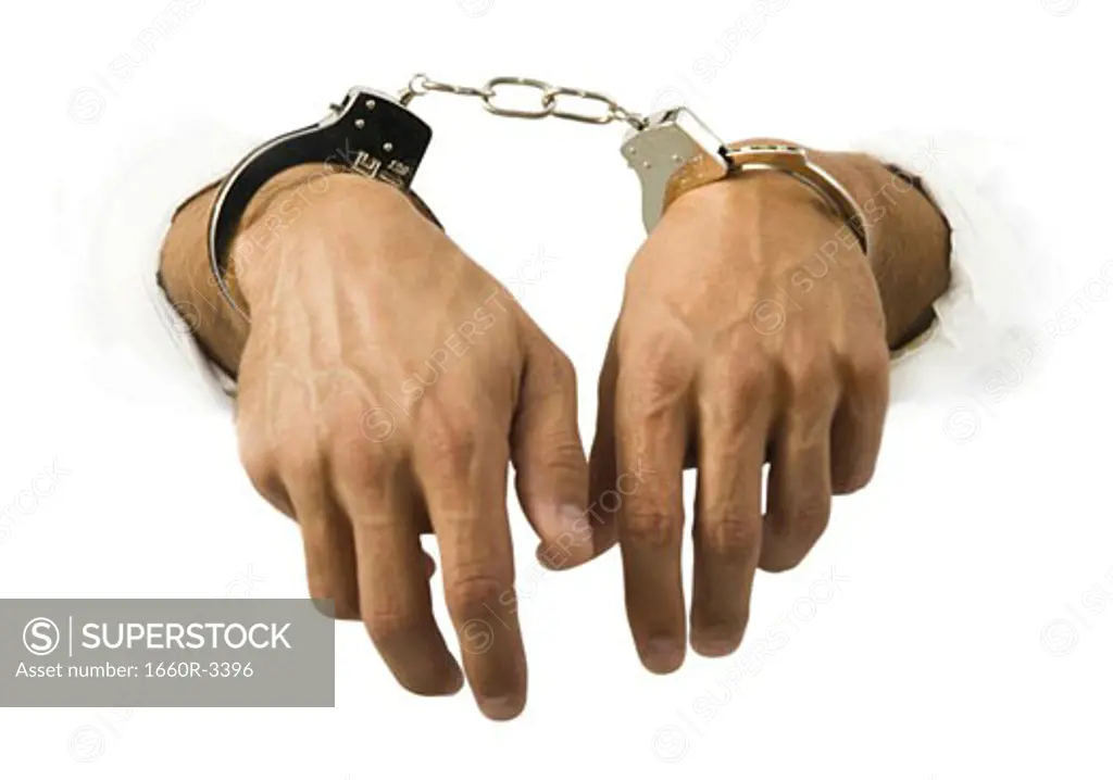 Close-up of hands in handcuffs