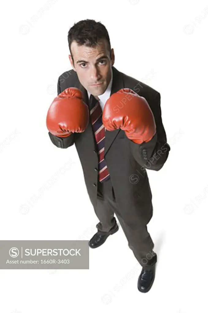 High angle view of a businessman wearing boxing gloves
