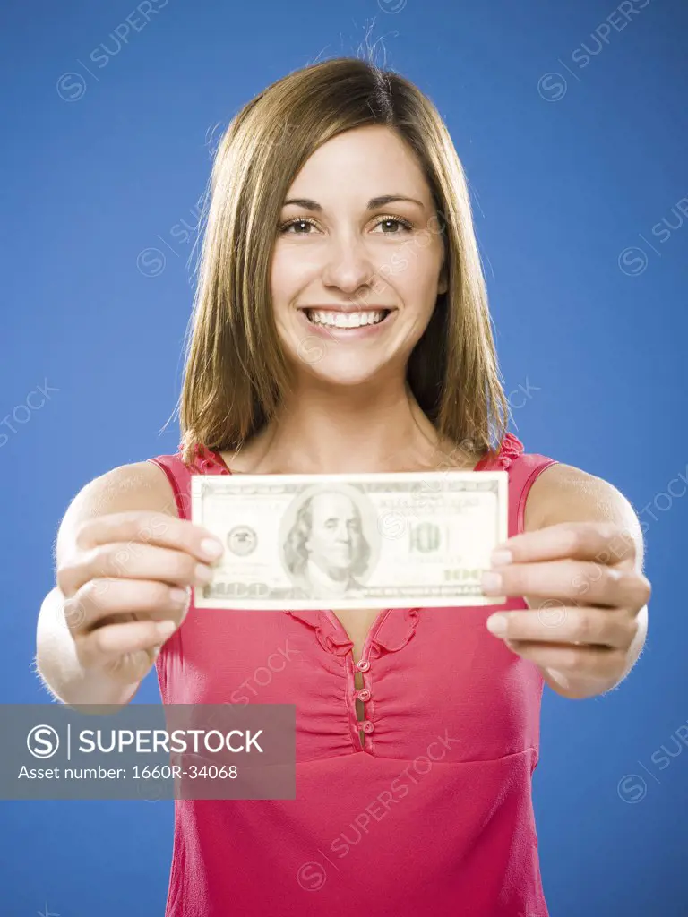 Woman holding American hundred dollar bill