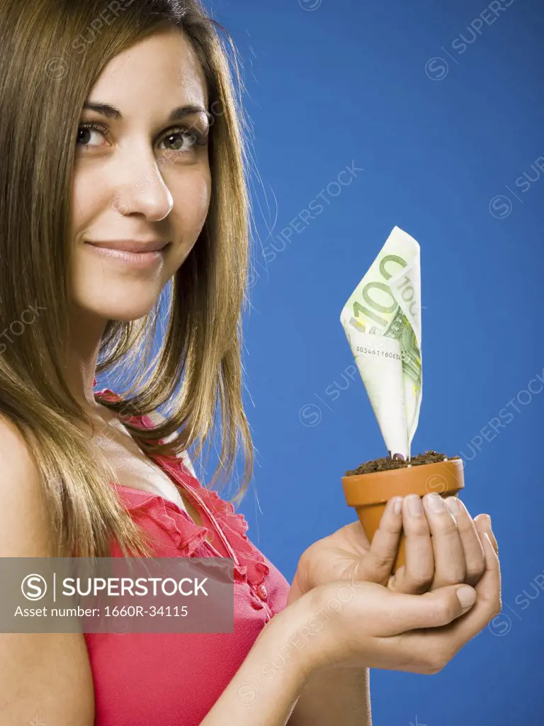 Woman holding euro money tree