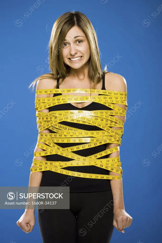 Woman wrapped in measuring tape