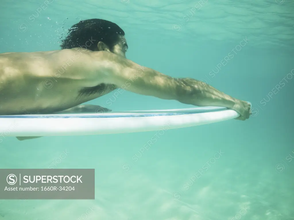 Man underwater water with surfboard