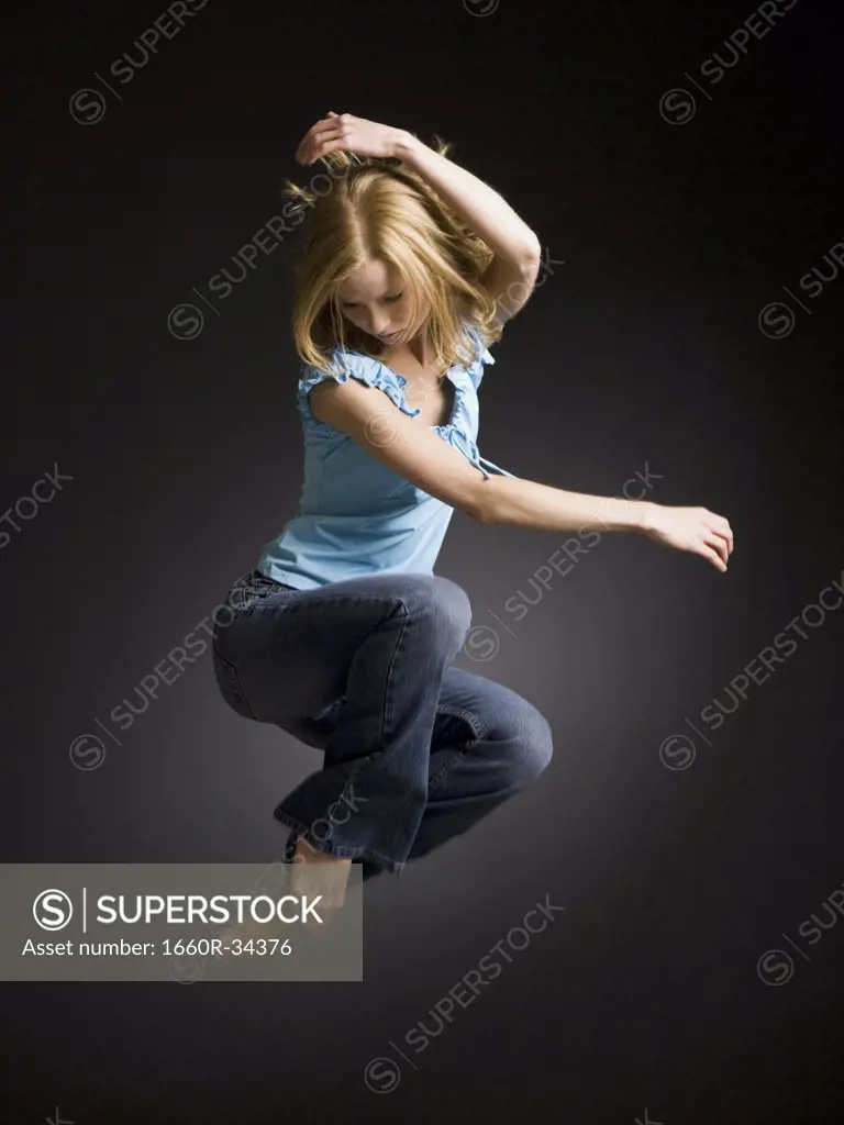 Woman jumping with arms up