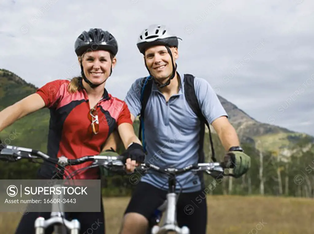 Portrait of a couple mountain biking