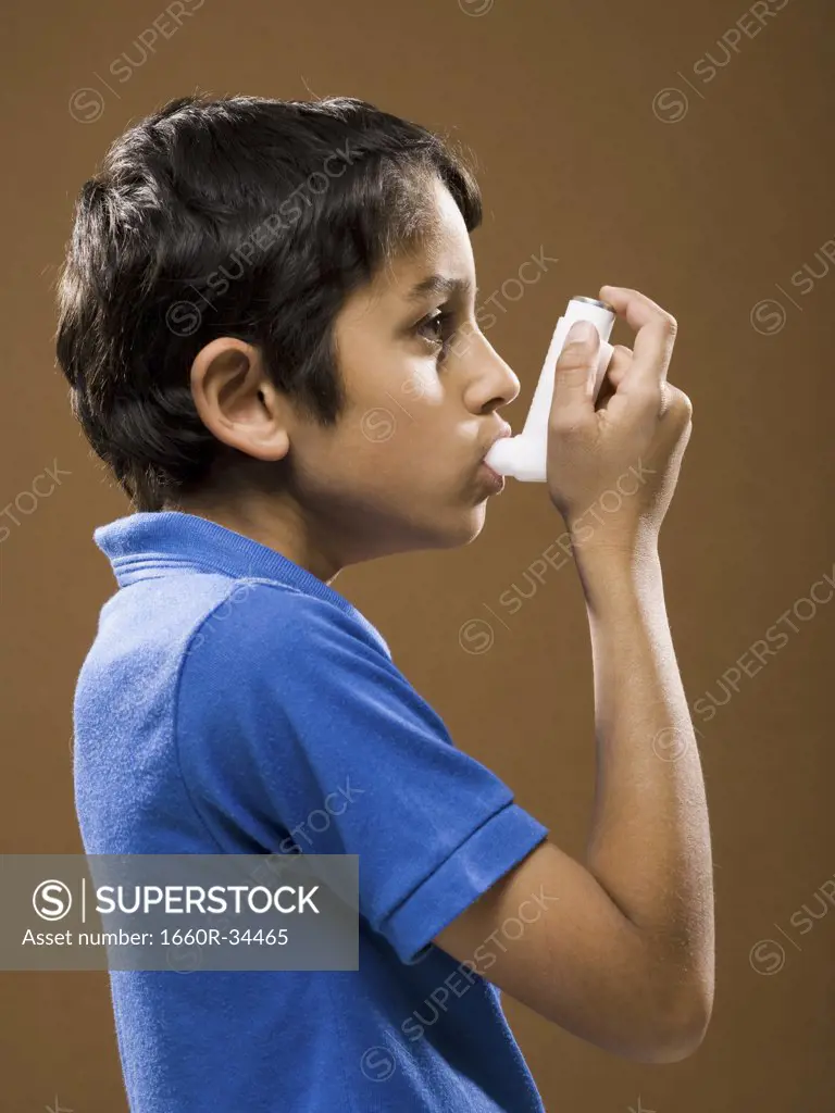 Boy with asthma inhaler profile