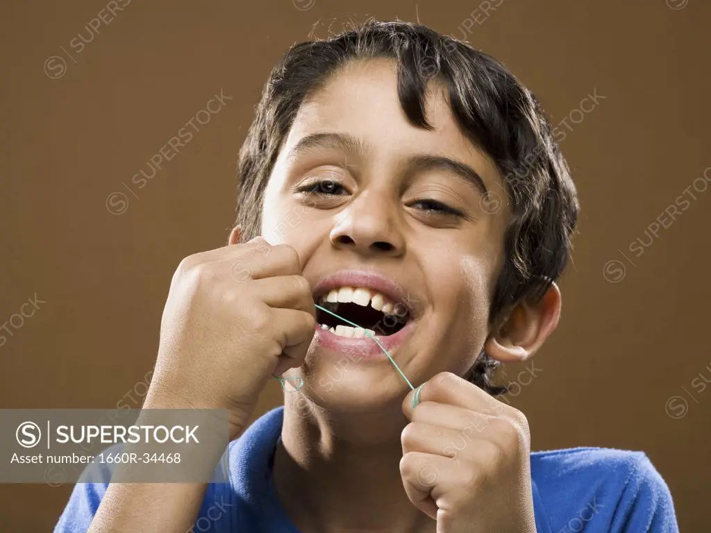 Closeup of boy flossing teeth