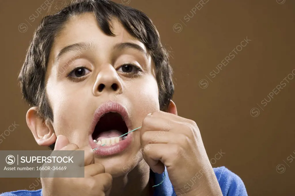 Closeup of boy flossing teeth