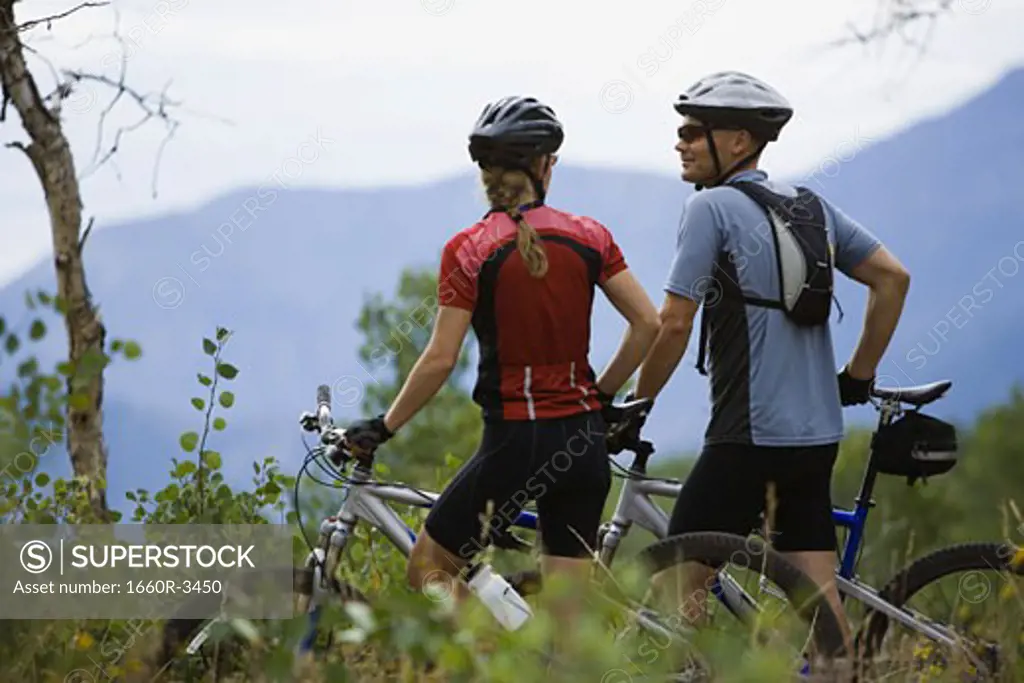 Rear view of a couple mountain biking