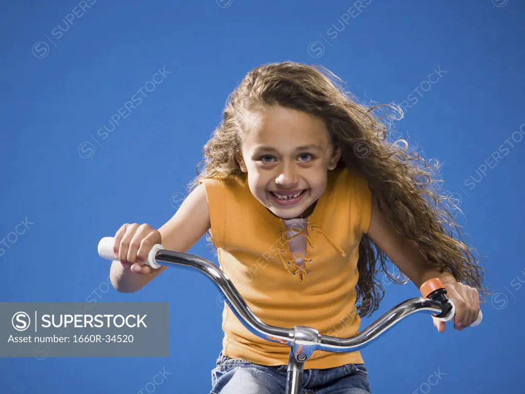 Girl riding bicycle and smiling