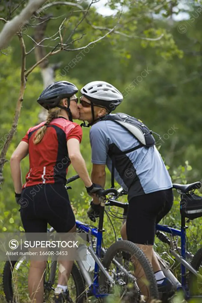 Rear view of a couple mountain biking