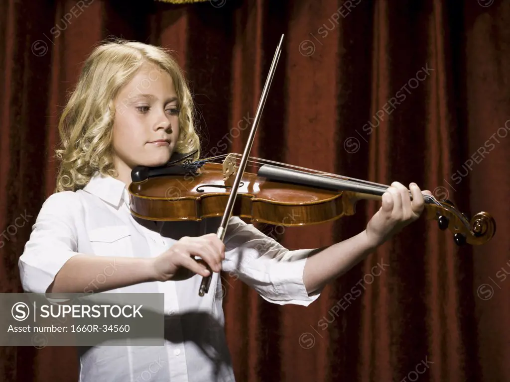 Girl playing violin on stage