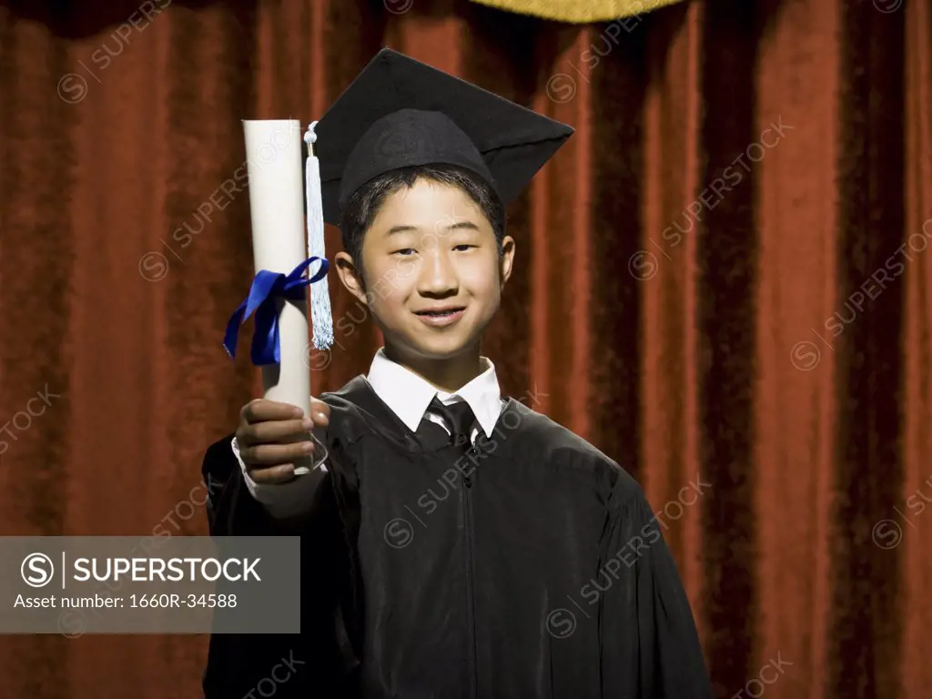 Boy graduate with mortar board and diploma smiling with braces