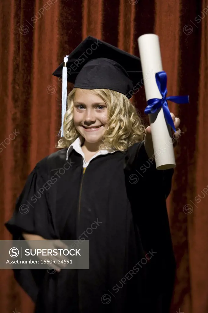 Girl graduate with mortar board and diploma smiling
