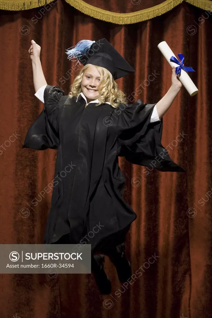 Girl graduate with mortar board and diploma smiling and cheering