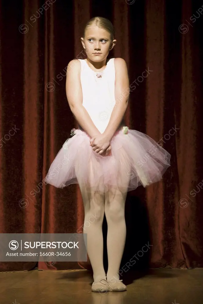Ballerina girl with hands clasped nervously